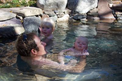 Family enjoying a open-air naturism in OLT&#039;s Apple Tree Pools